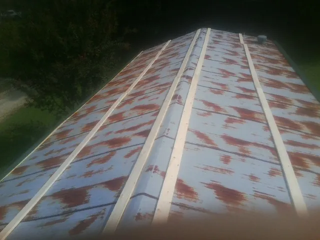 Rusted metal roof panels with new wood purlins before replacement — Storm Damage Roof Repair in Otterbein by Roofing Brothers