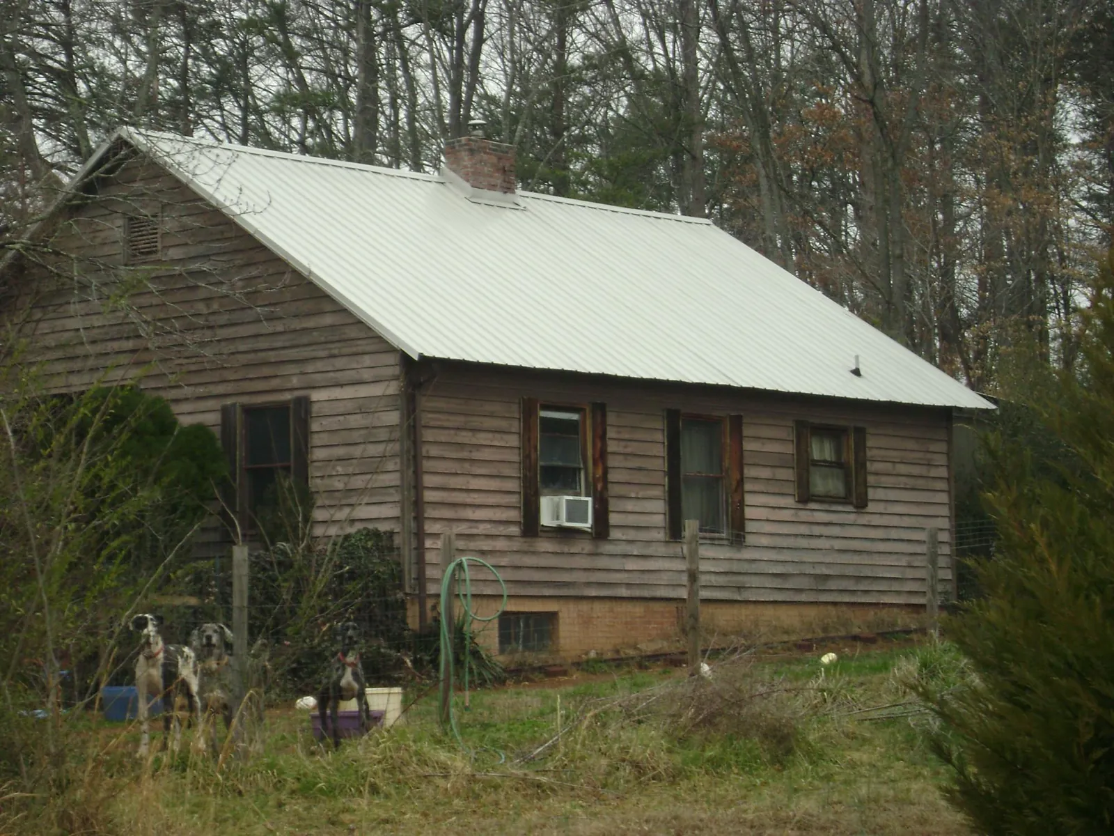 White metal roof on an old wood sided farmhouse, from a Metal Roof Installation job in Otterbein